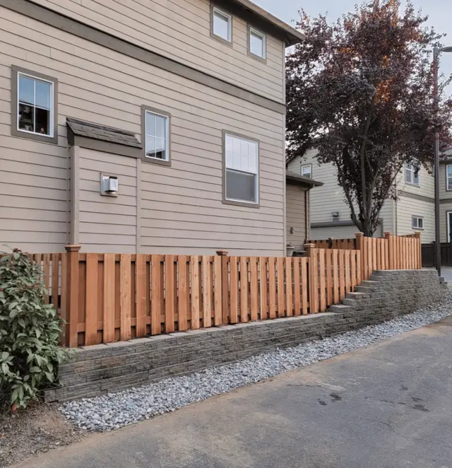 Cedar privacy fence above decorative retaining wall in Happy Valley OR – Oregon Quality Cuts