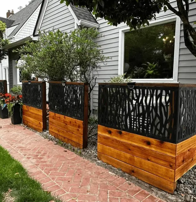 Decorative metal screen fence with cedar planter base along brick walkway in Portland OR – Oregon Quality Cuts