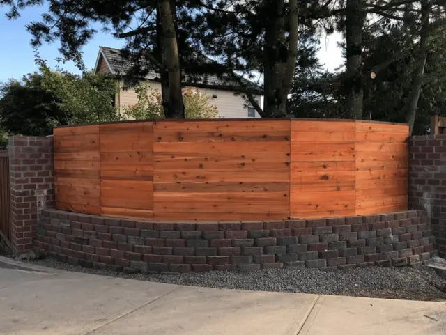 Horizontal cedar fence on brick retaining wall in Portland OR – Oregon Quality Cuts fence and wall project