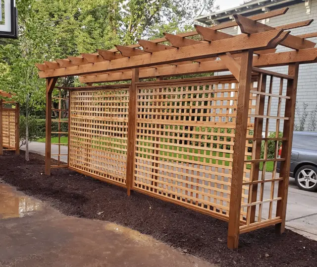 Close-up of custom cedar lattice pergola with mulch landscaping in Portland OR – Oregon Quality Cuts