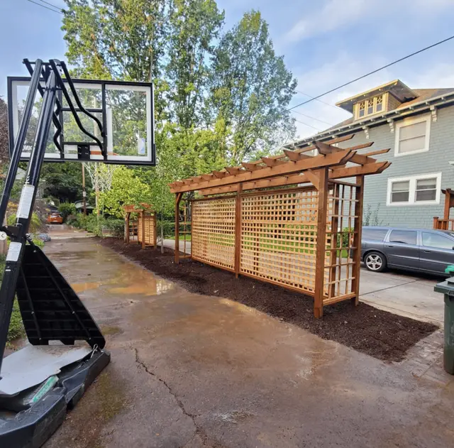 Cedar lattice pergola privacy screen installation along driveway in Portland OR – Oregon Quality Cuts