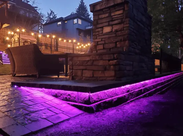 Custom outdoor living patio with fireplace and landscape lighting in West Linn OR – Oregon Quality Cuts